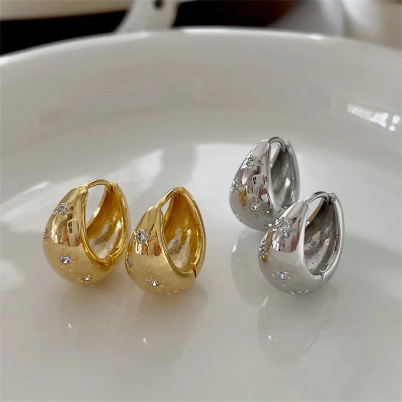 Boucles d'oreilles créoles en goutte dorées avec étoiles